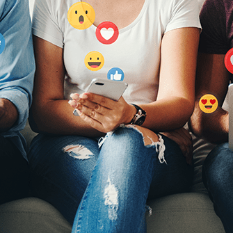 Three people looking at social media on mobile phones